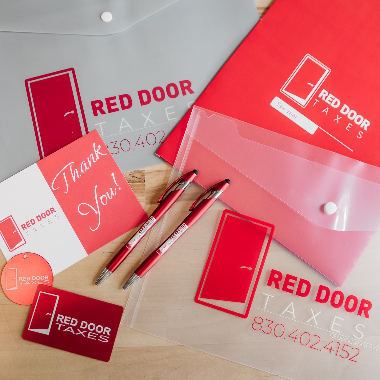 Red Door Taxes folders, cards, and pens